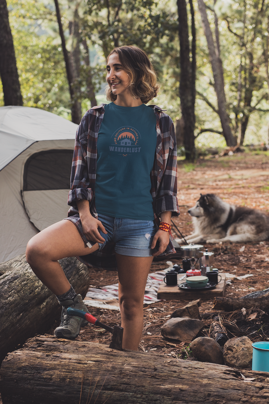 Young woman at a campfire wearing an oversized t-shirt — wanderlust outdoor adventure lifestyle
