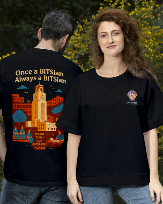 Two people wearing black t-shirts with BITS Pilani Design and Logo, standing in a natural setting with yellow flowers.